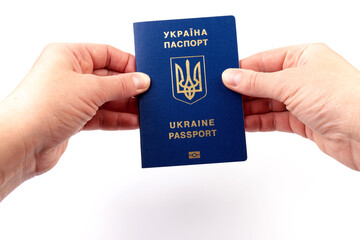 Passport of a citizen of Ukraine in a female hand on white background, close-up. Inscription in Ukrainian Ukraine Passport