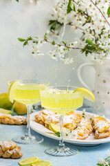 Limoncello. Traditional italian homemade alcoholic drink in glass with pieces of lemon, sweet Italian lemon liqueur. vertical image. top view. place for text