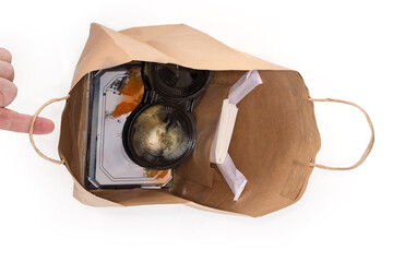 Top view of fast food in open packaging paper bag