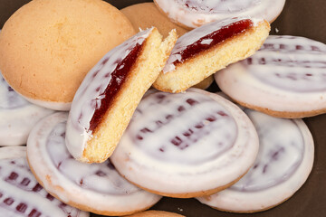 Cookies with white chocolate coating and jam filling close-up