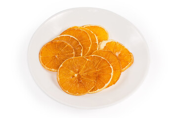 Orange fruit chips on white dish on a white background