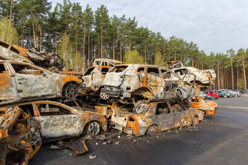 Fototapeta premium Civil cars shot and burned up by Russian soldiers, Ukraine
