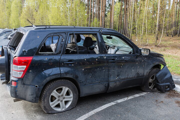 Obraz na płótnie Canvas Civil car shot up by Russian soldiers in Ukraine, 2022