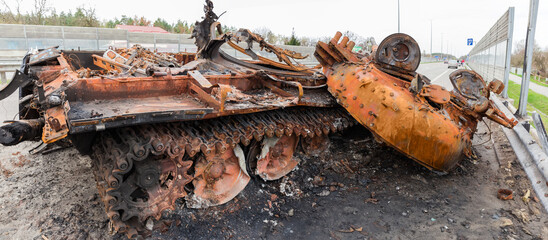 Destroyed russian tank on highway in invasion of Ukraine
