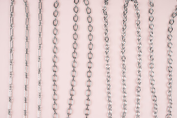 Set of different chains on a pastel background. Chain connection, types of metal chains. Connecting links in chains