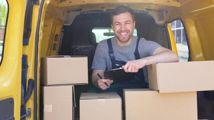 Courier with clipboard in delivery van outdoors