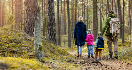 family hike in the forest with children. copy space - obrazy, fototapety, plakaty