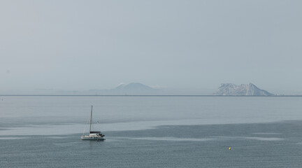 Boat anchored in the bay on a calm sea day