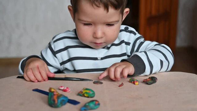 Close up of kid fist pounding on a table,, sculpts from plasticine. 