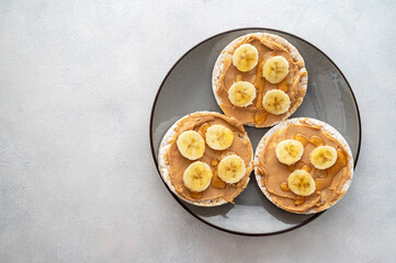 Peanut butter over rice cakes and honey. Healthy protein snack for breakfast