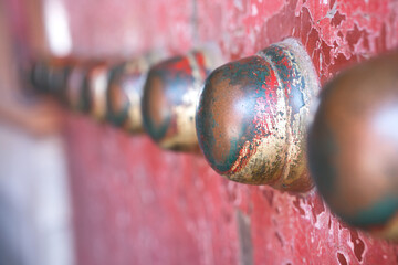 Close up of copper nails on vermilion gate
