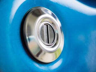 Close-up view of the key hole on a blue car