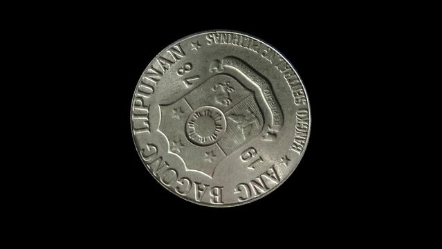 Rotating obverse of Philippines coin 1 piso 1978 with inscriptions meaning NEW SOCIETY, REPUBLIC OF PHILIPPINES, CENTRAL BANK OF PHILIPPINES. Isolated in black background.
