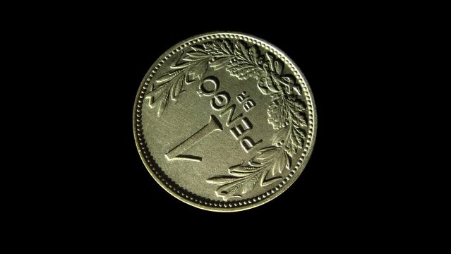 Rotating reverse of Hungary coin 1 pengo 1938 with inscription meaning ONE PENGO, BUDAPEST. Isolated in black background.