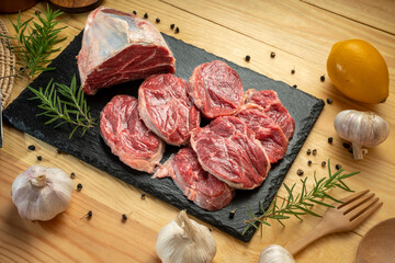Premium Shank beef in black stone plate on wooden background.Fresh Silver shank meat in black plate...
