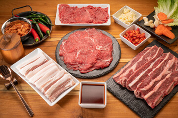 Mixed fresh Beef and pork belly set for BBQ grilling with Kimchi, fresh vegetables, fresh chili and dipping sauce, Korean BBQ.