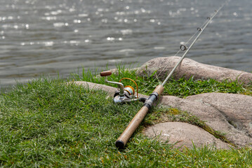 Spinning on the river bank. Fishing on the river.