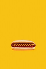 Classic hot dog with wurst, ketchup and mustard on orange background. Menu for restaurant