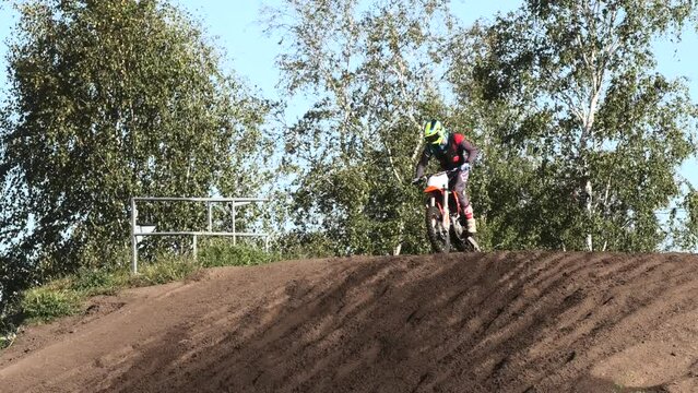 Dirt bikes jumping on motocross circuit in Arnhem, the Netherlands, with visiible hill