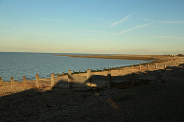 Late summer strolling over the sands on the beaches of Whitstable, Kent, UK taking in the sights...