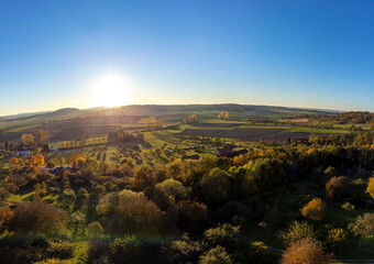 Fototapeta na wymiar Aerial shot of scenic autumn landscape at sunset in Southern Germany