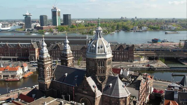 Amsterdam, Netherlands. Aerial view of Basilica of Saint Nicholas with panoramic view of city centre, and historic building of Central Station.