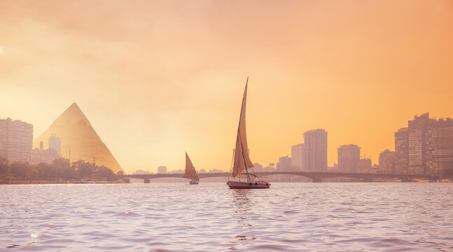 Sunset river Nile with white yacht background egyptian pyramid Cairo, Egypt