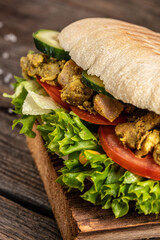 Grilled club sandwich panini with with crispy chicken and salad on cutting board. Turkish chicken doner sandwich. Fast food. vertical image. top view. place for text
