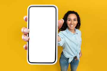 Woman showing white empty smartphone screen close to camera