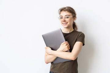 Fototapeta premium Portrait of a businesswoman carrying laptop isolated over white background