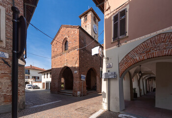 Caramagna Piemonte, Piedmont, Italy - May 10, 2022: ancient medieval Palazzo della Credenza with the clock tower in via Luigi Ornato