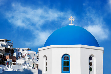 Fototapeta na wymiar The traditional greek blue dome of the orthodox church with blue sky background.