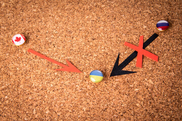Canadian assistance to Ukraine concept. Pins with national flags. Conflict between Ukraine and...