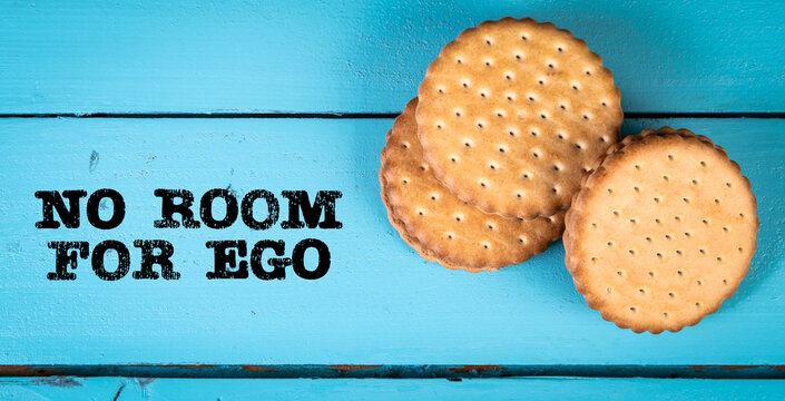 NO ROOM FOR EGO. Stack of cookies on a blue wood texture