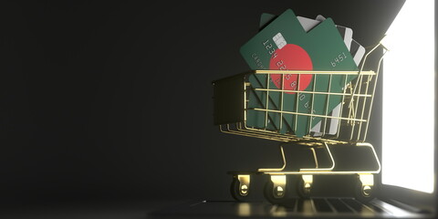 Bank card mockups with flags of Bangladesh in a small shopping cart on the laptop. 3D rendering