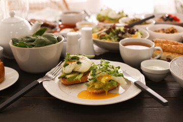 Delicious sandwiches and many different dishes served on buffet table for brunch