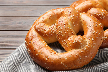 Tasty freshly baked pretzels on table, closeup view