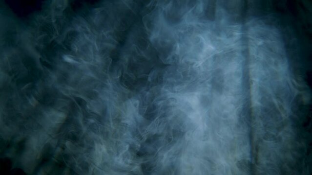 Slow Motion Abstract White Smoke Floating With Black Background Showing Light Beams