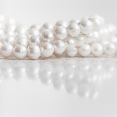 Nature white string of pearls on marble background in soft focus