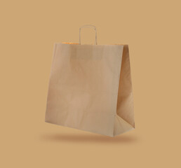 Kraft paper bag on beige background. Mockup for design