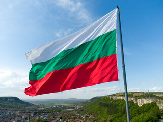 Bulgaria National Flag Waving on pole against sunny blue sky background - obrazy, fototapety, plakaty