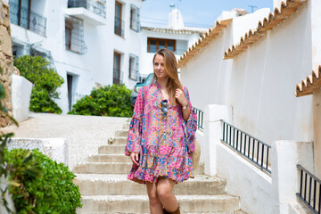 Young blonde woman walking in the mediterranean tourist town of Altea, Alicante, Spain