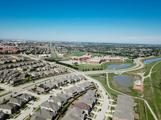 Top view urban sprawl and residential neighborhood to horizontal line with elementary school district in Irving, Texas