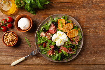 Salad with burrata cheese and croutons.