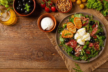 Salad with burrata cheese and croutons.