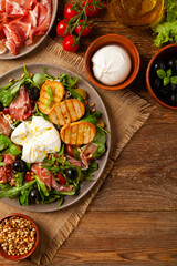 Salad with burrata cheese and croutons.