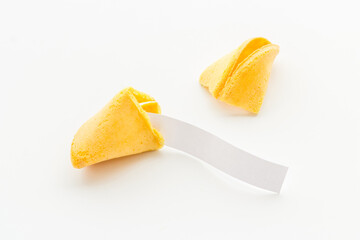 Broken Chinese fortune cookie with blank slip outside