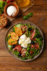 Salad with burrata cheese and croutons.