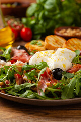 Salad with burrata cheese and croutons.