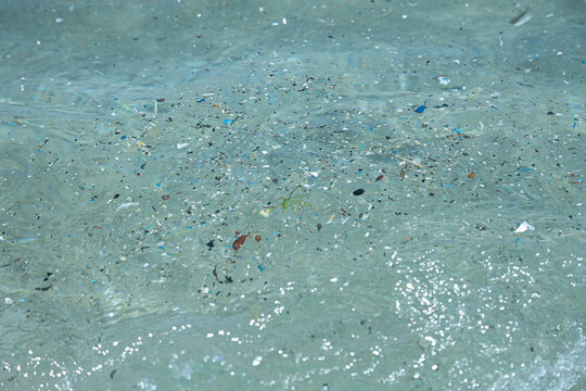 microplastic particles float in the ocean, water pollution